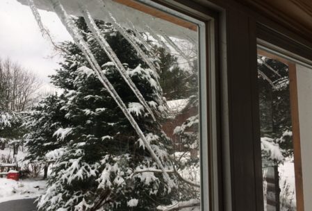 we've gotten two separate 8 - 12" snowfalls in our time here, and as the snow slides down on the roof, the icicles start to curve inwards!